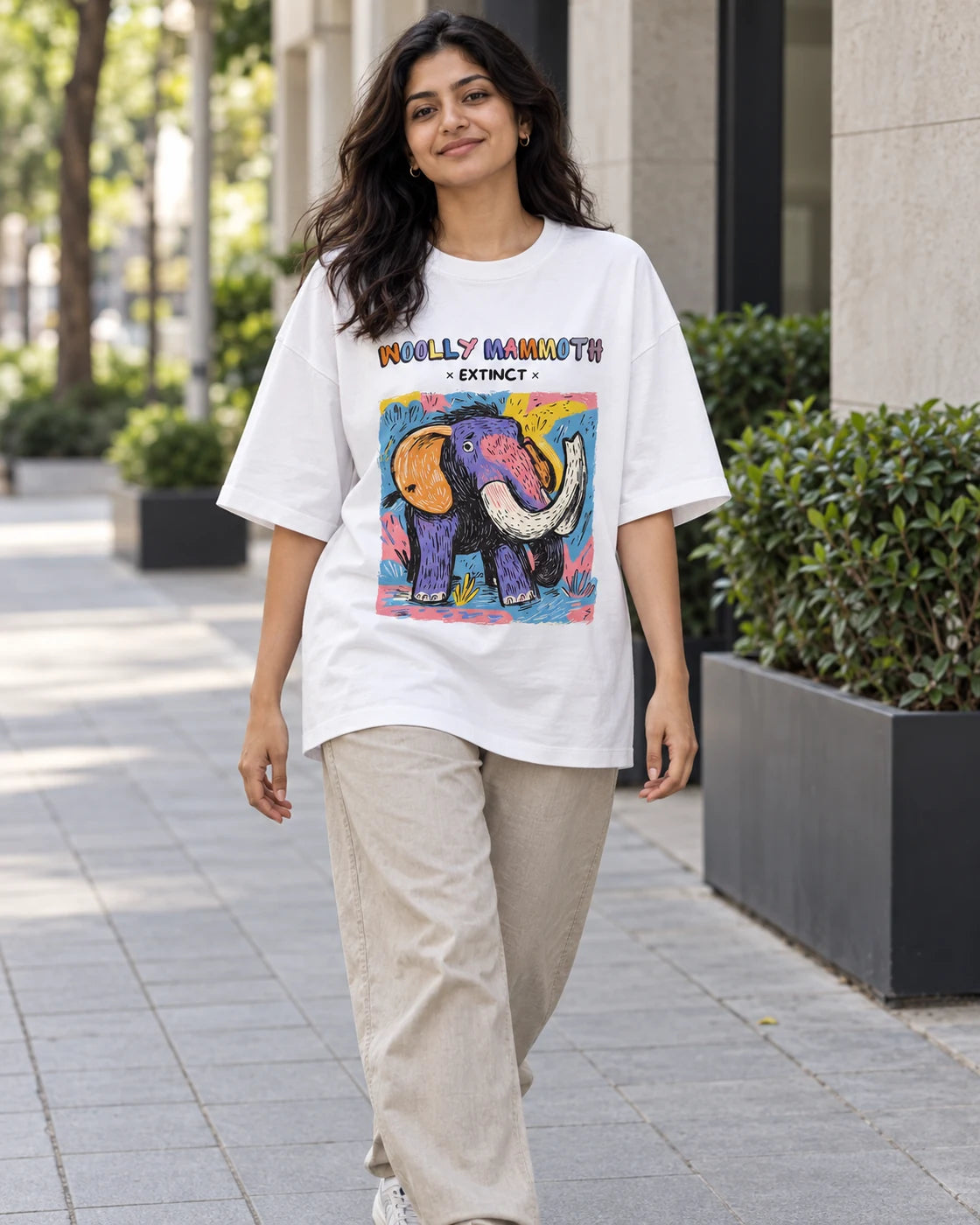 Model wearing the Woolly Mammoth white oversized French terry T-shirt on a city street, Fourth Dimension Club