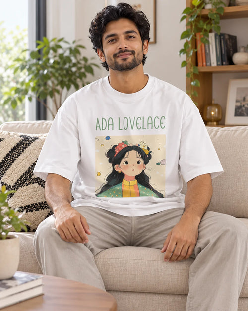 Model wearing the Ada Lovelace Genius Doodles oversized French terry T-shirt by Fourth Dimension Club, seated on a sofa