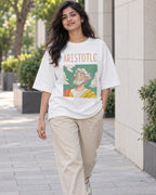 Model wearing the Aristotle Genius Doodles oversized French terry T-shirt by Fourth Dimension Club on a city street