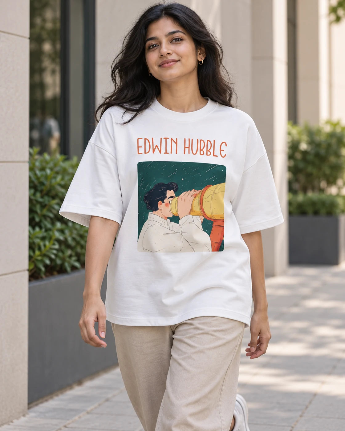 Model wearing the Edwin Hubble Genius Doodles oversized French terry T-shirt by Fourth Dimension Club on a city street