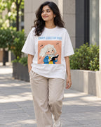 Model wearing the Johann Sebastian Bach Genius Doodles oversized French terry T-shirt by Fourth Dimension Club on a city street