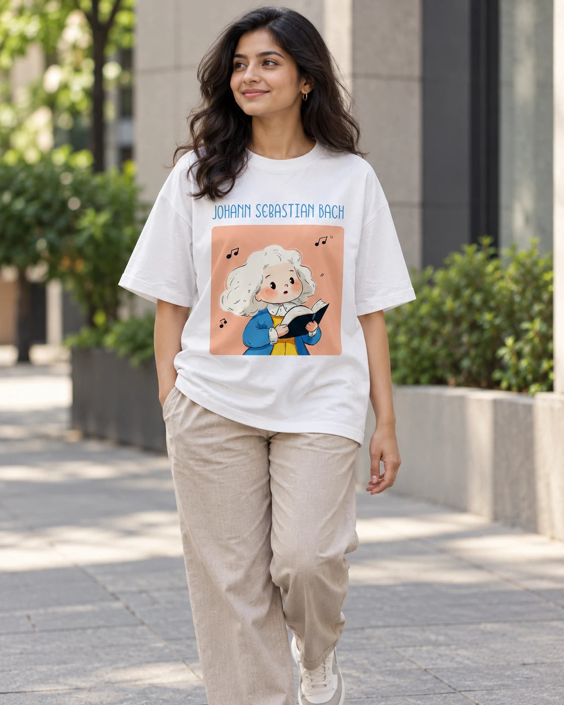 Model wearing the Johann Sebastian Bach Genius Doodles oversized French terry T-shirt by Fourth Dimension Club on a city street
