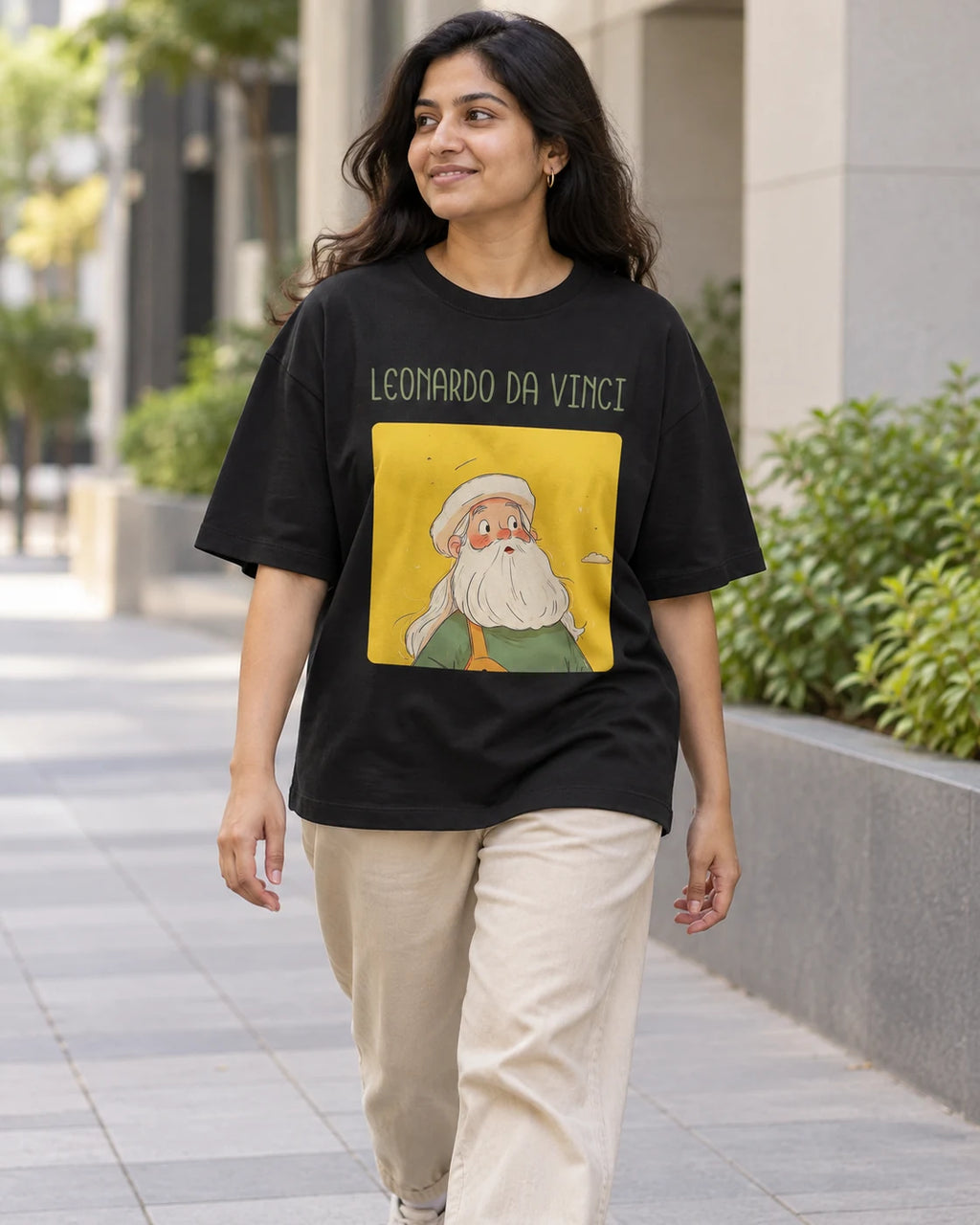 Model wearing the Leonardo da Vinci Genius Doodles oversized French terry T-shirt by Fourth Dimension Club on a city street