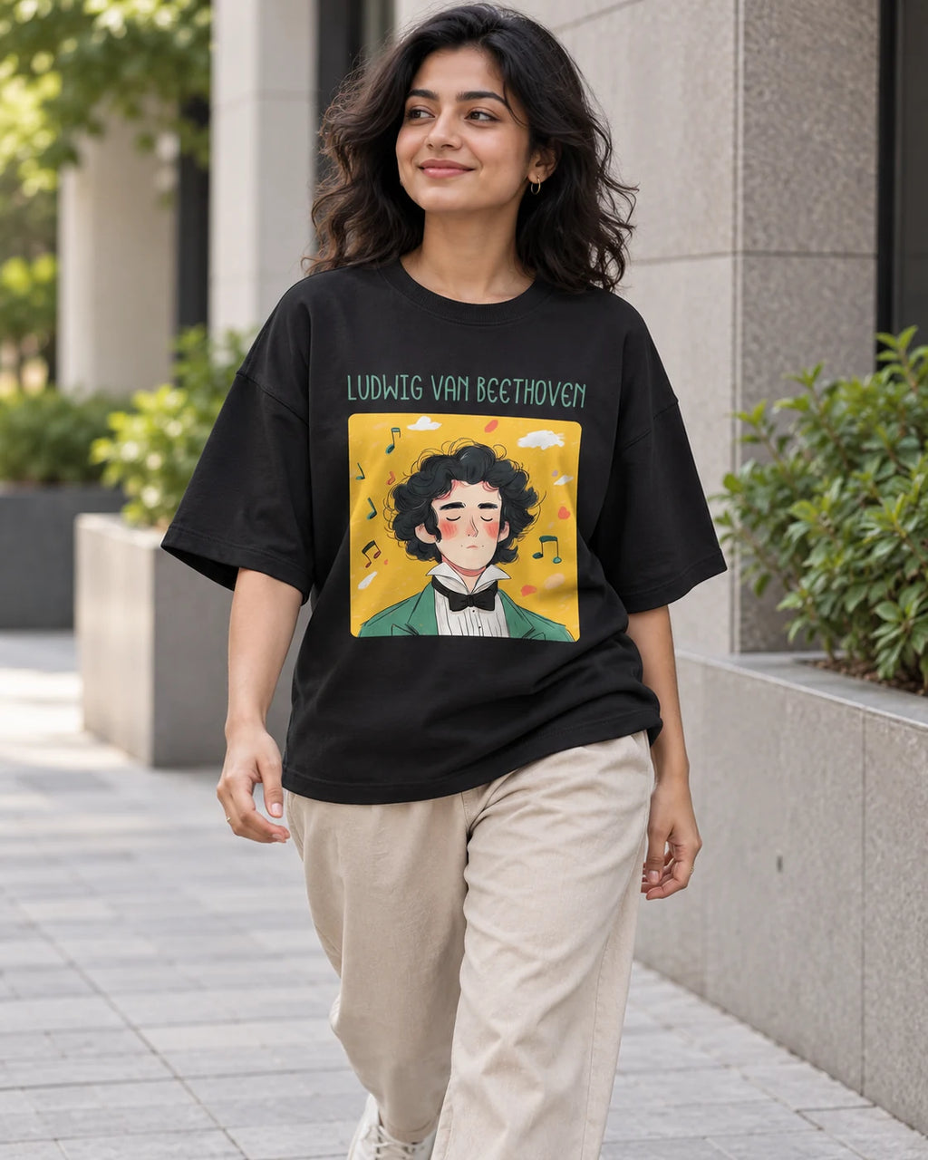 Model wearing the Ludwig van Beethoven Genius Doodles oversized French terry T-shirt by Fourth Dimension Club on a city street