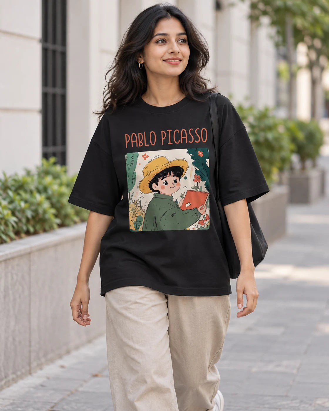 Model wearing the Pablo Picasso Genius Doodles oversized French terry T-shirt by Fourth Dimension Club on a city street
