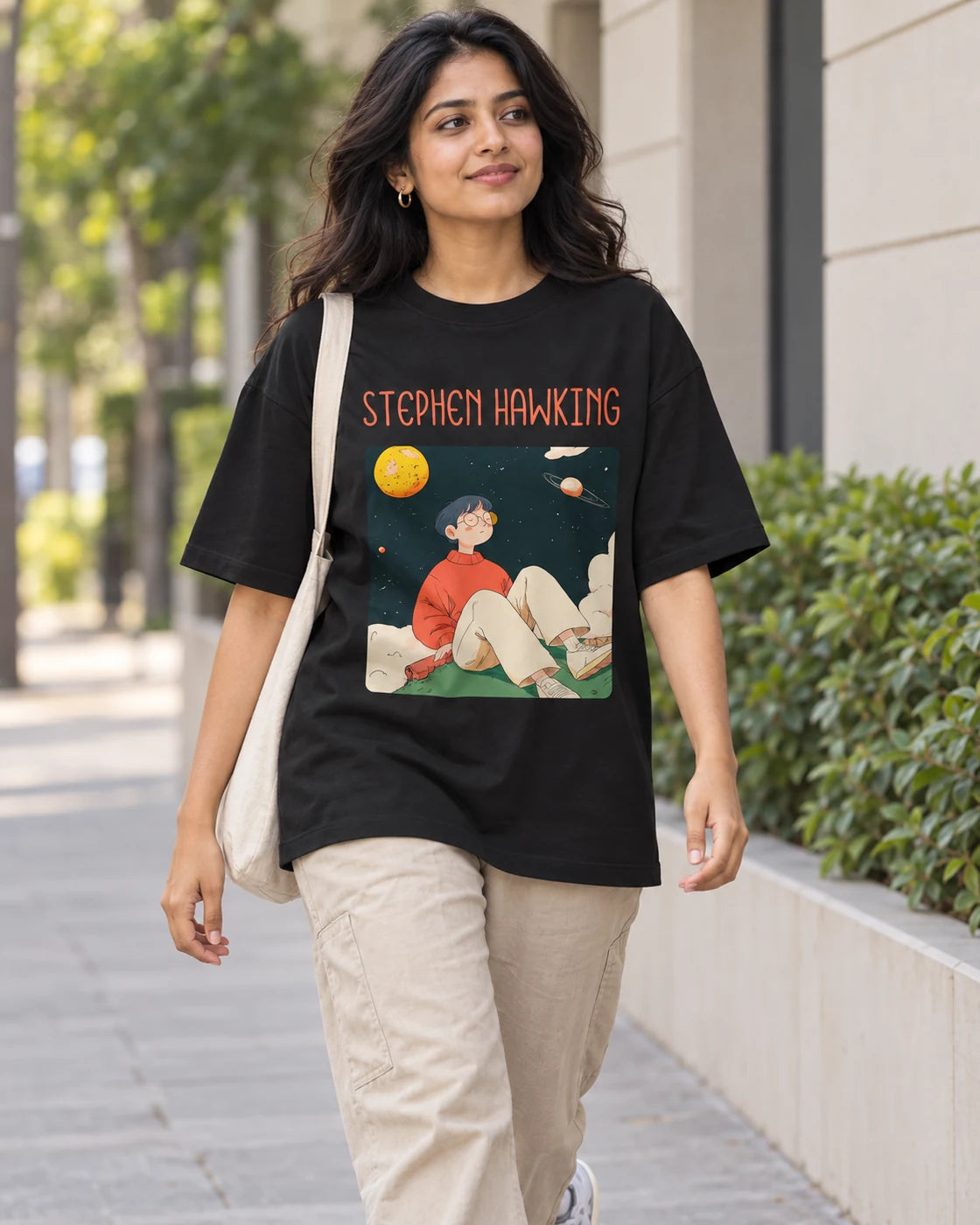Model wearing the Stephen Hawking Genius Doodles oversized French terry T-shirt by Fourth Dimension Club on a city street