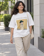 Model wearing the Werner Heisenberg Genius Doodles oversized French terry T-shirt by Fourth Dimension Club on a city street