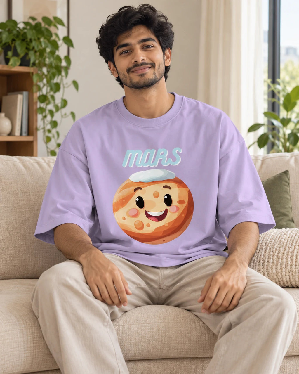 Model wearing the Mars Stellar Squad oversized French terry T-shirt in lavender by Fourth Dimension Club, seated on a sofa