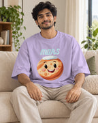 Model wearing the Mars Stellar Squad oversized French terry T-shirt in lavender by Fourth Dimension Club, seated on a sofa