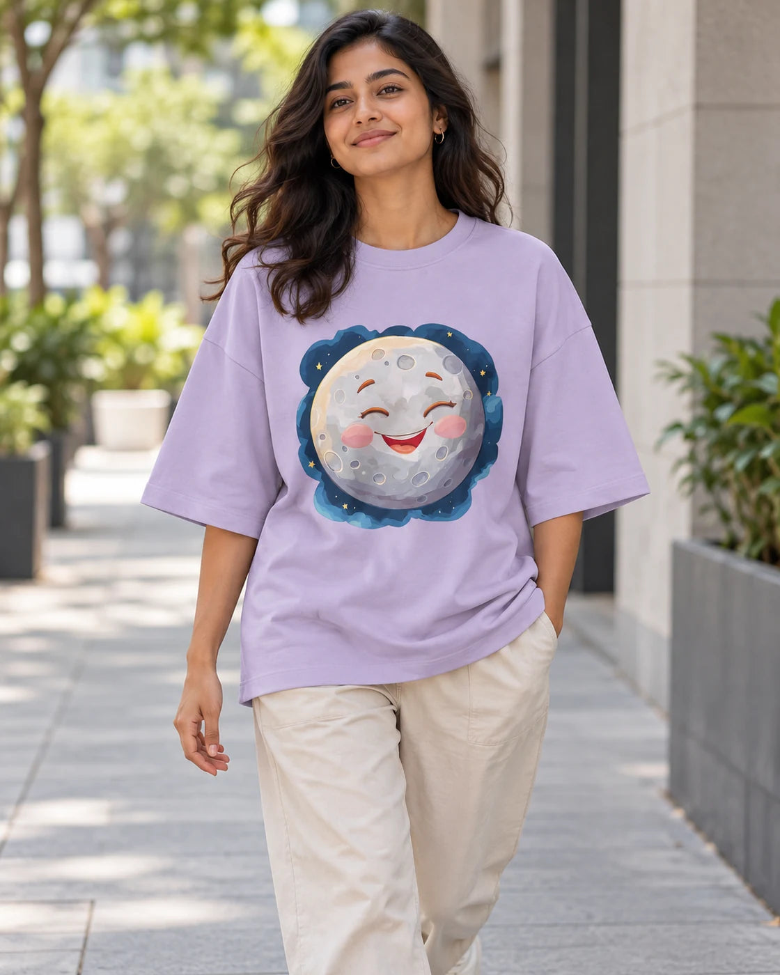 Model wearing the Moon Stellar Squad oversized French terry T-shirt in lavender by Fourth Dimension Club on a city street