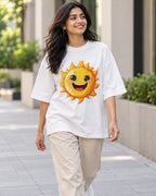 Model wearing the Sun Stellar Squad oversized French terry T-shirt in white by Fourth Dimension Club on a city street