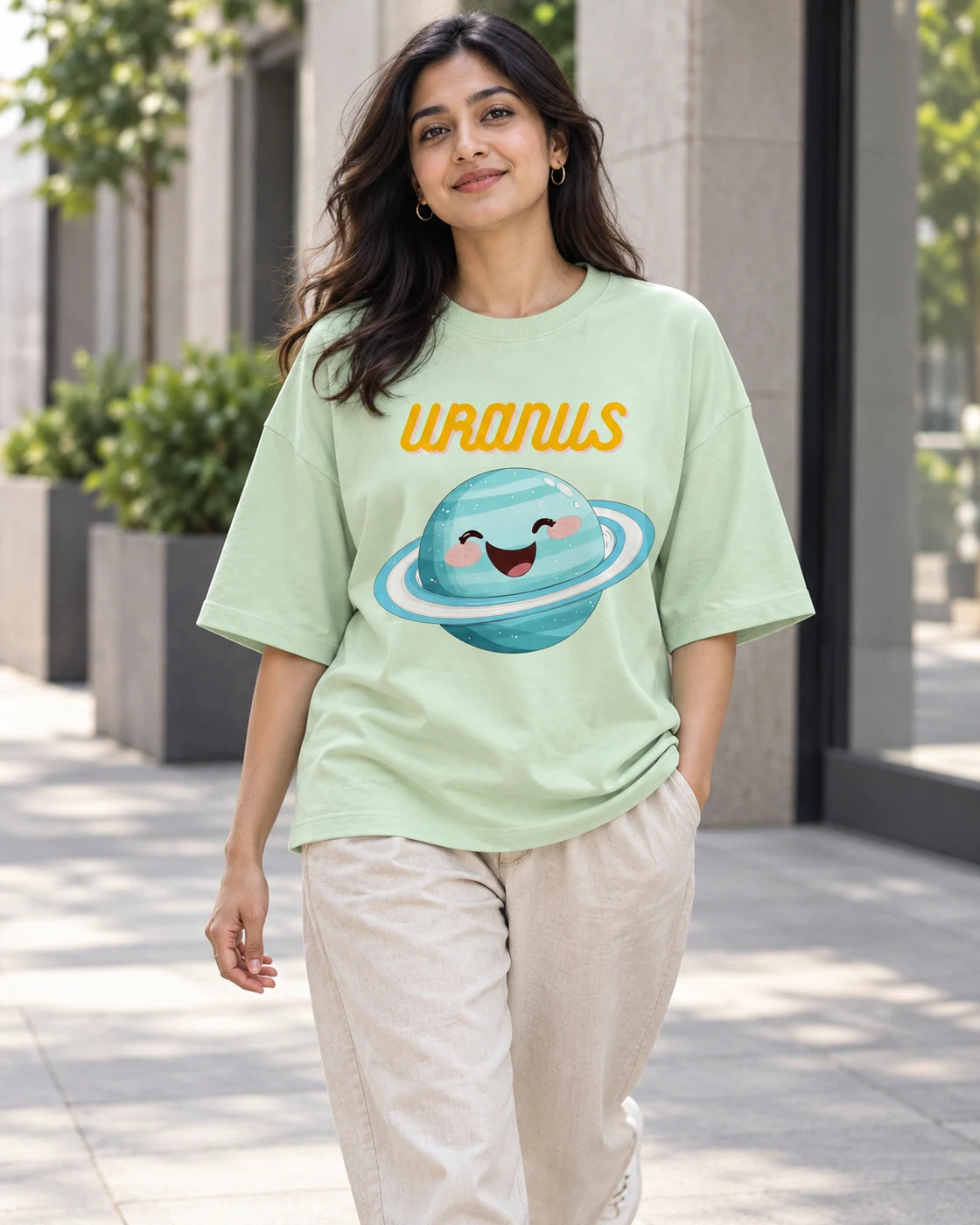 Model wearing the Uranus Stellar Squad oversized French terry T-shirt in jade by Fourth Dimension Club on a city street
